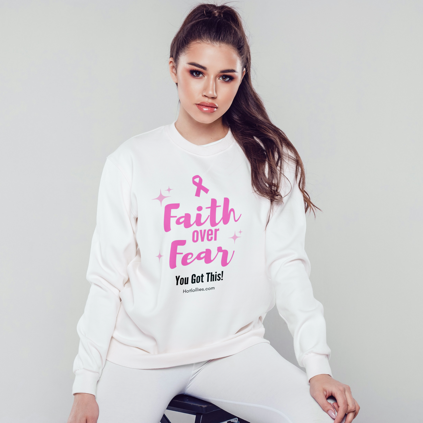 Woman wearing a white sweatshirt with pink 'Faith Over Fear' text, above 'You Got This' text