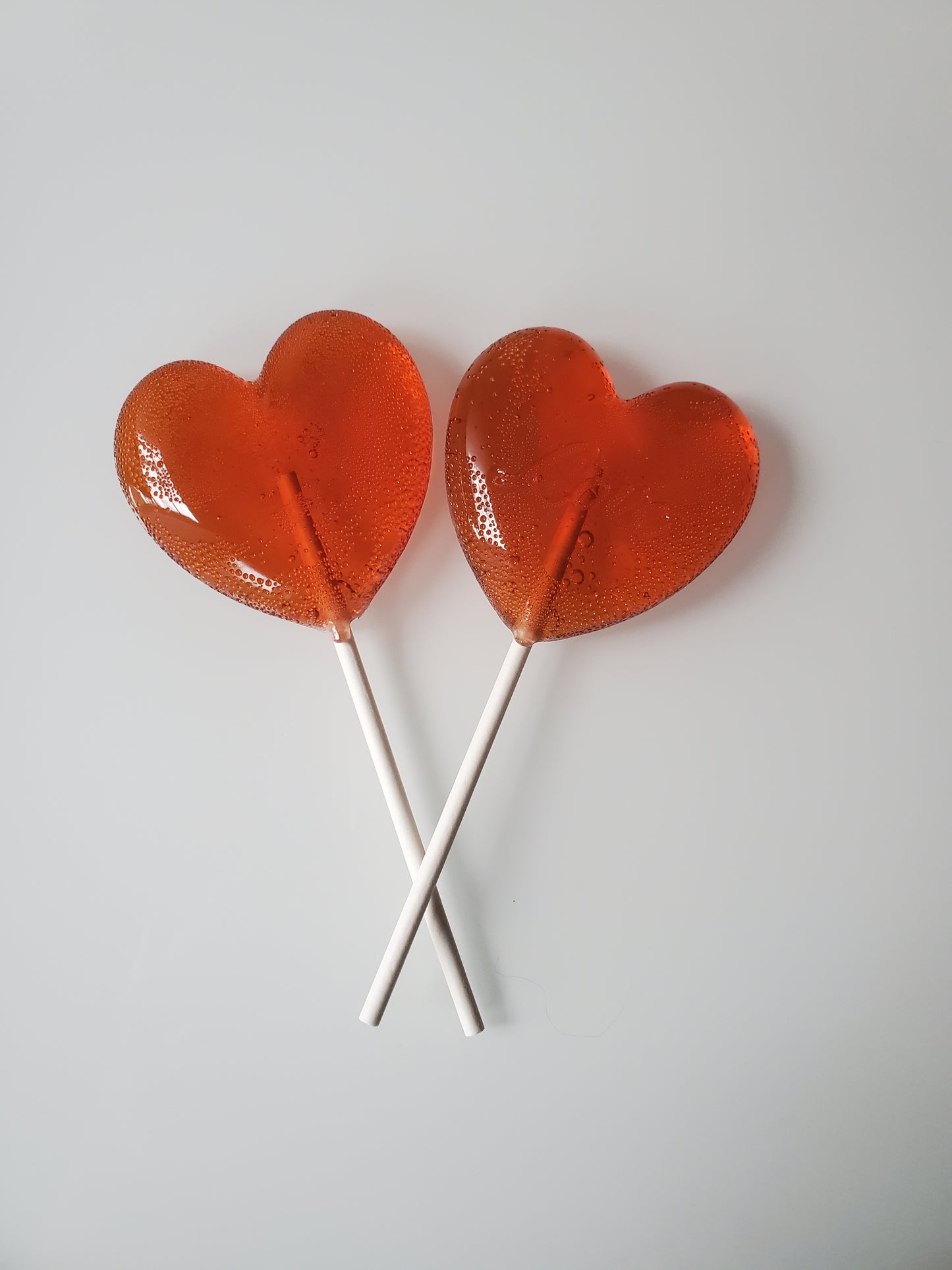 Two red Valentine's heart shaped lollipops