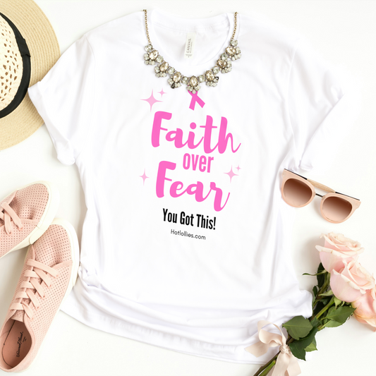 White t-shirt with 'Faith over Fear' text, pink sneakers, straw hat, sunglasses, and flowers on a white background