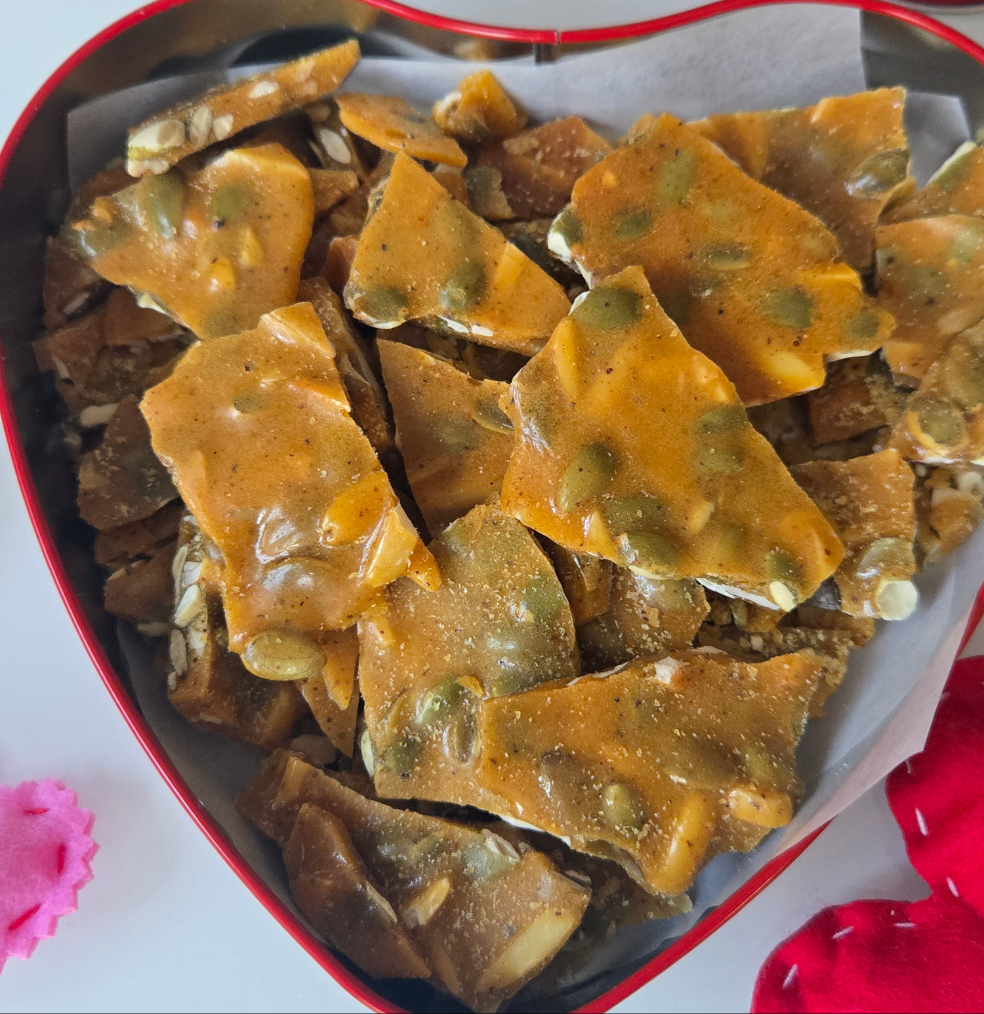 Close up if candy brittle in red tin heart for Valentine's day