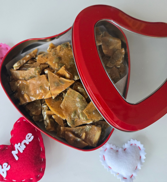 Red valentine's Day heart filled with almond and pepitas brittle