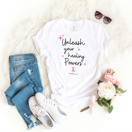 White t-shirt with 'Unleash your healing powers' text, jeans, sneakers, and flowers on a white background